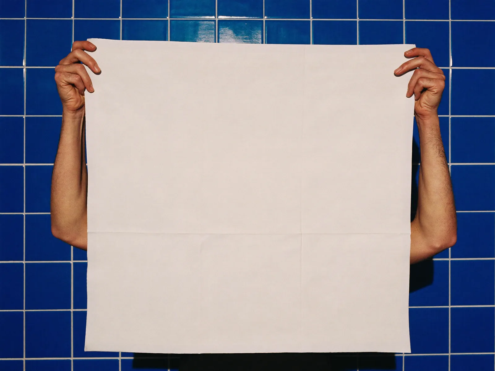 Two hands holding up an extra-large cloth.